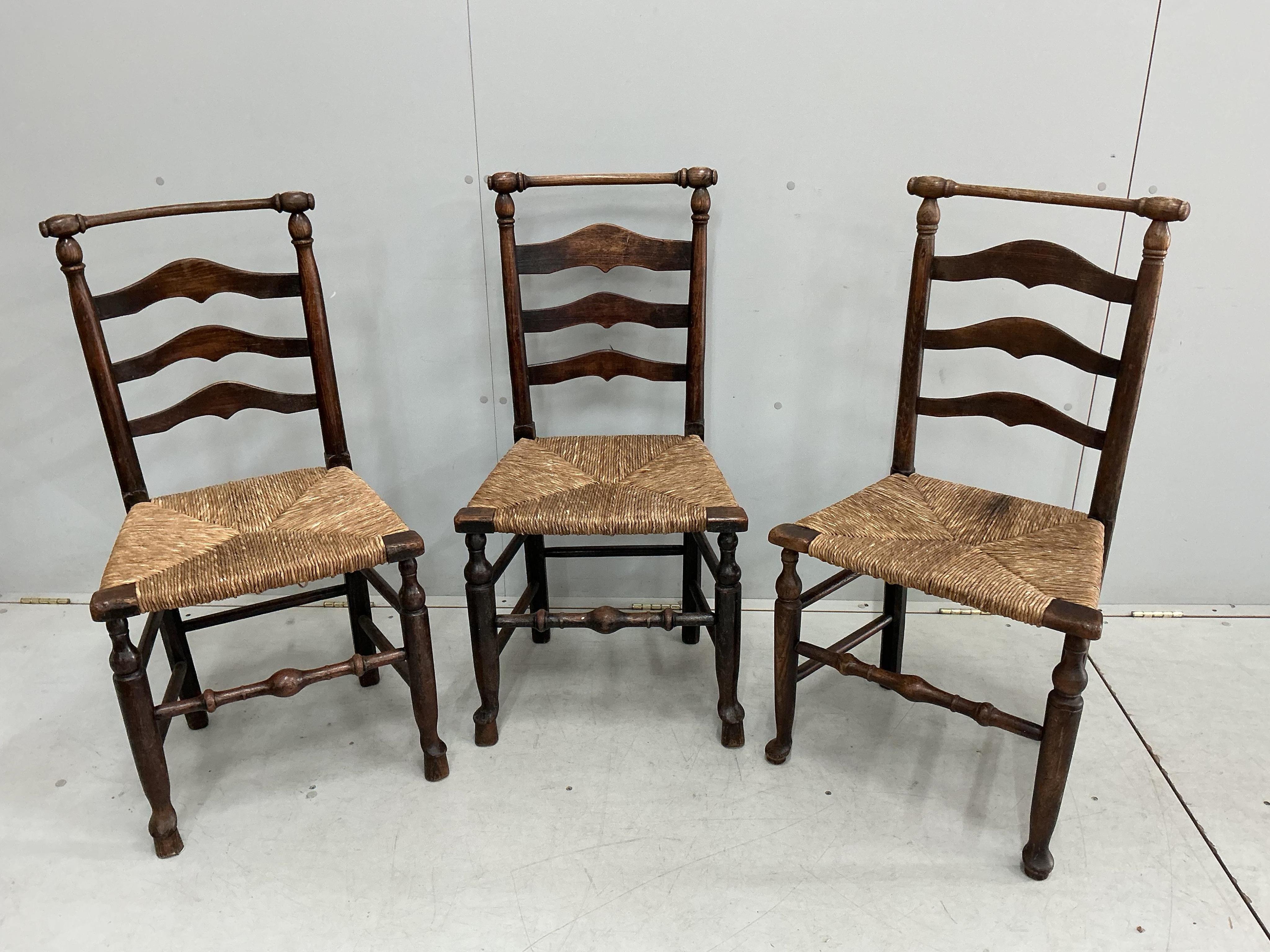 A harlequin set of eight 18th century ash ladderback rush seat dining chairs, two with arms